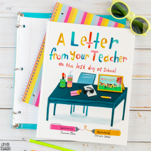A colorful children’s book titled A Letter from Your Teacher on the Last Day of School, perfect for student gifts, rests on top of open notebooks with a pair of yellow sunglasses nearby on a white wooden surface.