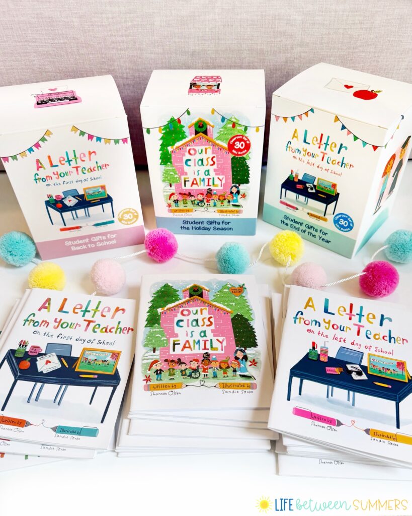 Colorful teacher-themed gift boxes and books are arranged on a white surface, creating a warm and inviting display. The books, titled A Letter from Your Teacher and Our Class is a Family, highlight the importance of building classroom community. Pom-poms and a logo reading Life Between Summers add playful touches to the scene.