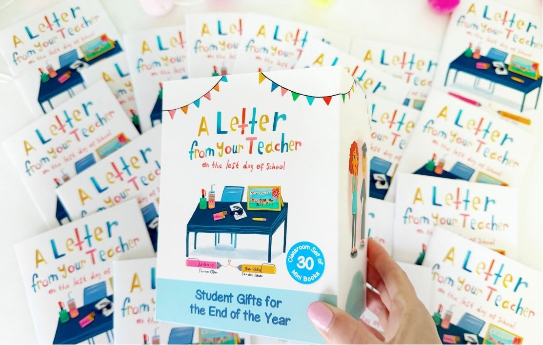 A hand holds a box labeled A Letter from Your Teacher with an illustration of a desk; several identical boxes are spread out in the background. The box mentions Student Gifts for the End of the Year.