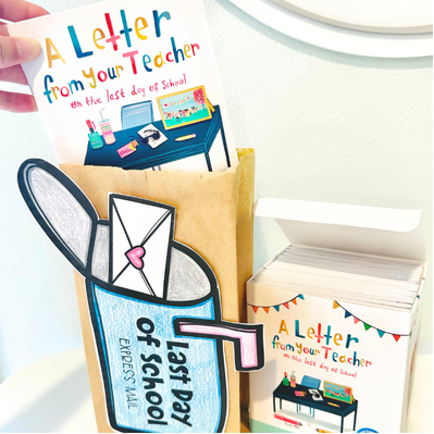 A hand holds an illustrated card titled A Letter from Your Teacher on the Last Day of School above a brown paper bag decorated with a mailbox and envelope cutout. A stack of cards in a box is also visible.