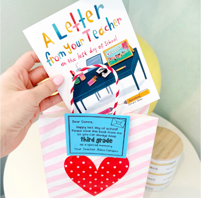 A hand holds a card titled A Letter from Your Teacher on the Last Day of School above a pink-striped gift bag with a red heart and a blue note about moving on to third grade.
