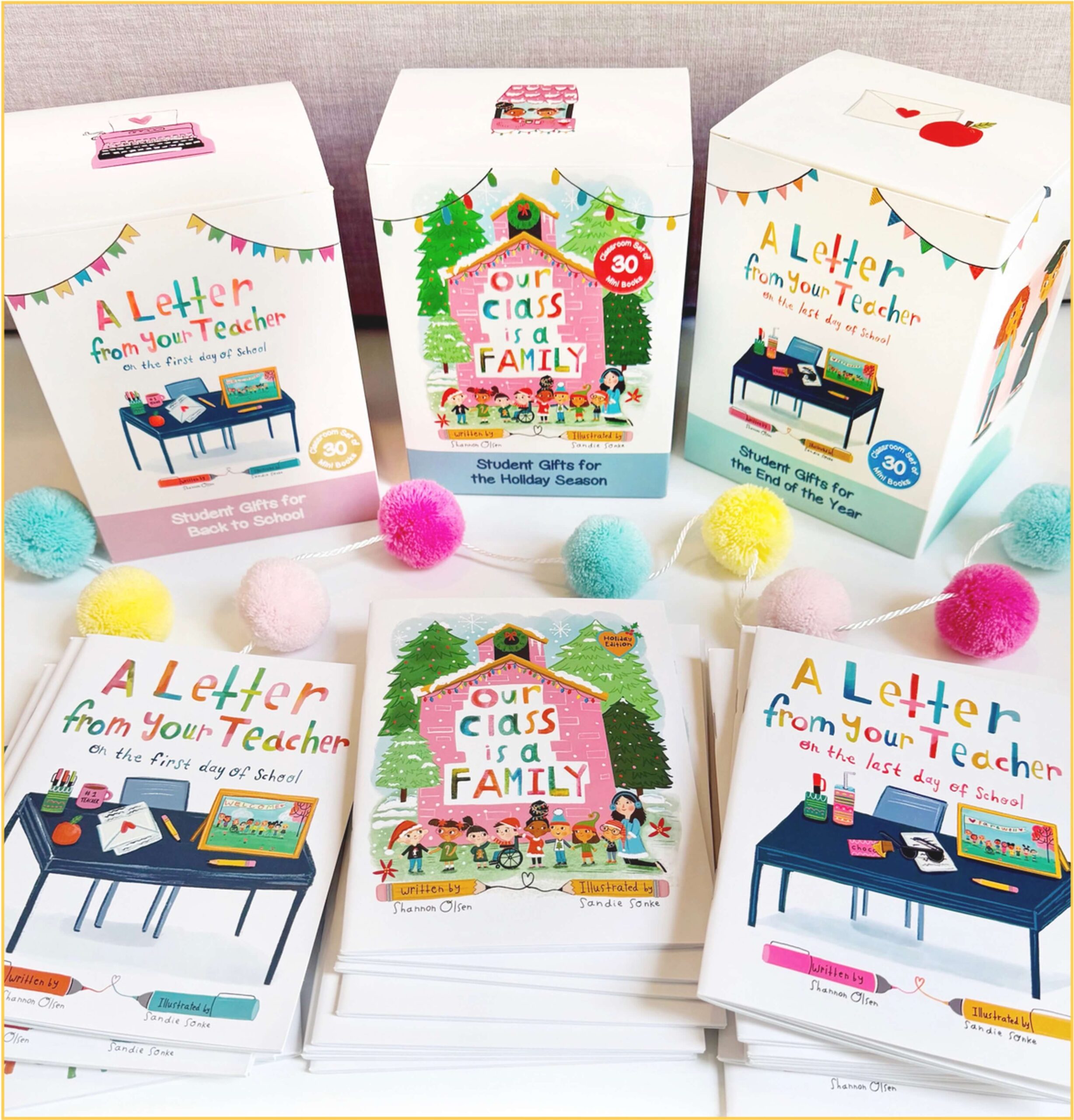 Colorful display of children’s books titled “A Letter from Your Teacher” and “Our Class is a Family,” with matching gift boxes and pastel pom-pom garland in the background.