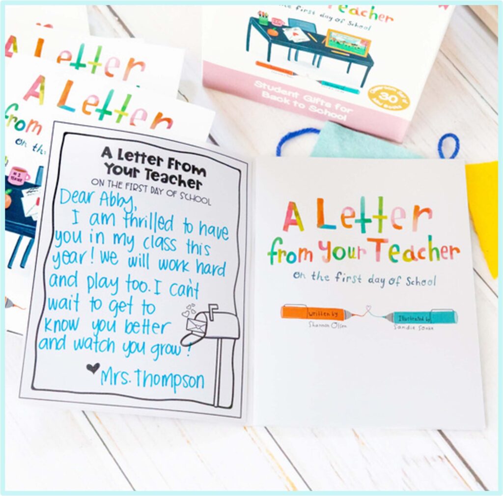 An open card reads, A Letter From Your Teacher On The First Day Of School with a handwritten note from Mrs. Thompson to Abby. Colorful text and other similar cards and a gift box are visible in the background.