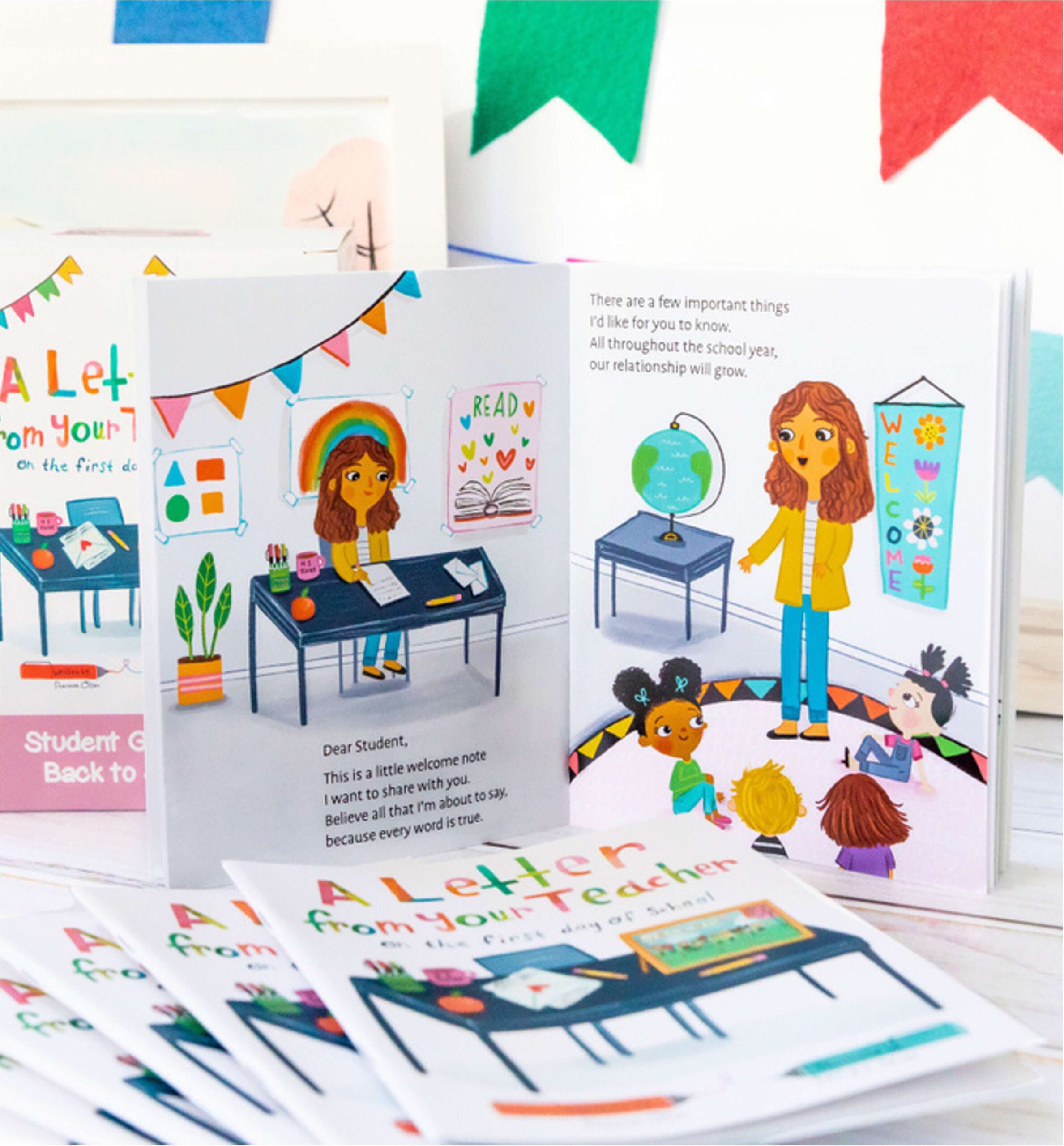 Illustrated cards featuring a smiling teacher in a classroom with students, colorful decorations, and welcome messages. The cards are titled “A Letter from Your Teacher on the First Day of School.”.