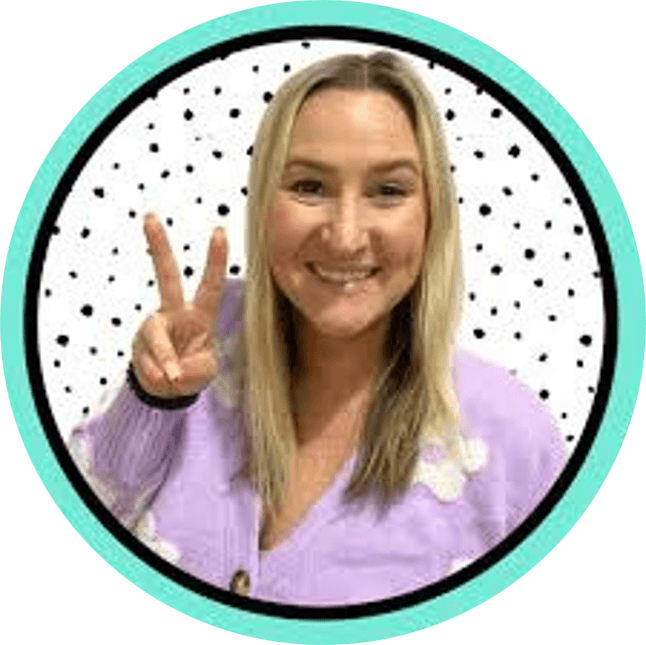 Smiling person with long blonde hair wearing a lavender sweater flashes a peace sign. The background is white with black dots and a teal circular border.